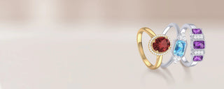 Three rings with gemstones on a light background