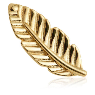 Gold feather-shaped jewelry piece on a white background