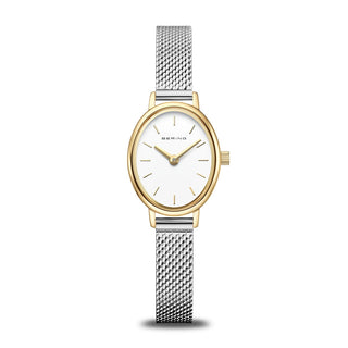 Watch with gold case and silver mesh band on a white background