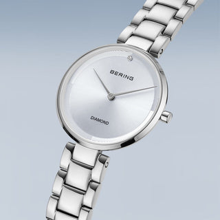 Silver Bering watch with diamond accents on a light gray background