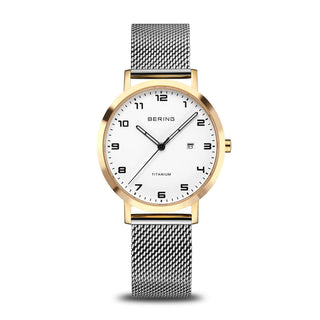 Watch with gold case and silver mesh strap on a white background