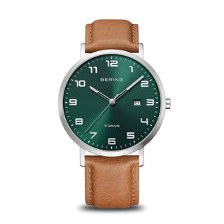 Wristwatch with green dial and brown leather strap on a white background