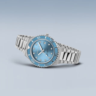 Silver watch with a blue face on a light gray background