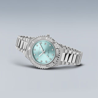 Silver watch with a light blue face on a gray background