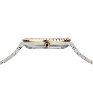 Close-up of a watch with gold and silver band on a white background