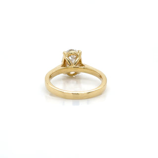 Gold ring with a diamond on a white background