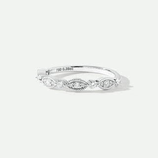 Silver ring with diamonds on a light gray background