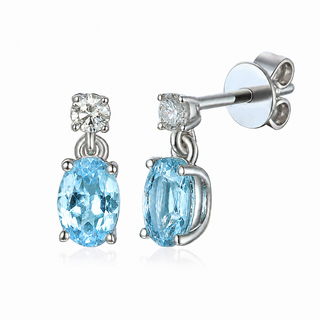 Pair of 18ct white gold earrings with blue gemstones on a white background