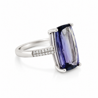 Ring with a large purple gemstone and smaller diamonds on a white background