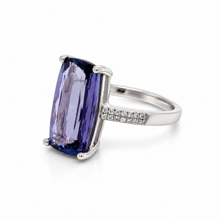 White Gold ring with a large purple gemstone and smaller diamonds on a white background