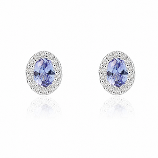 Pair of earrings with blue gemstones and silver or gold frames on a white background