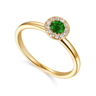 Gold ring with a green gemstone and diamond accents on a white background