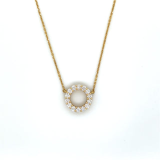 Gold necklace with a circular pendant on a white background