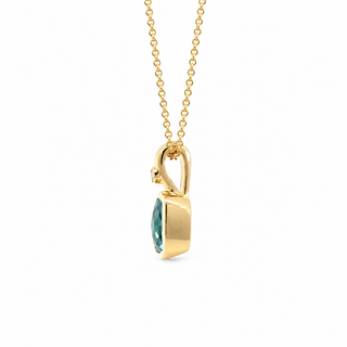 A gold pendant necklace featuring a marquise-cut green gemstone in a polished bezel setting, suspended from a delicate gold chain against a plain white background.