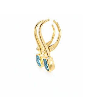 Gold earring with blue gemstones on a white background