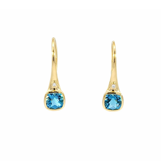 Gold earrings with blue gemstones on a white background