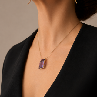 Necklace with a pendant worn by a person against a neutral background