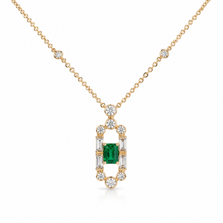 A gold necklace with a geometric pendant featuring a central green emerald-cut gemstone surrounded by small clear stones, shown on a white background.