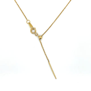 Gold necklace with a small pendant on a white background