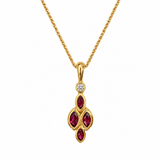 A gold pendant necklace featuring three marquise-cut deep red gemstones in a vertical cluster, accented by a small round clear stone above, suspended from a gold chain on a white background.
