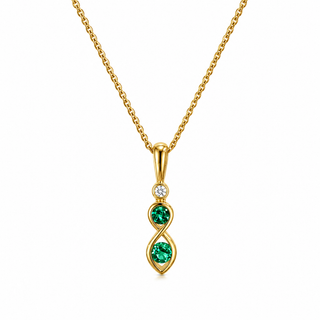 A gold pendant necklace featuring a vertical infinity-shaped setting with two round green gemstones and a small clear accent stone, shown on a white background.
