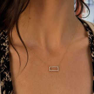 Necklace with a rectangular pendant worn by a person