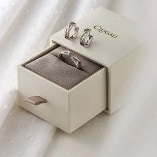 Silver earrings in a Clogau jewelry box on a light background