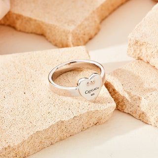 A clogau heart shaped ring on a piece of rock