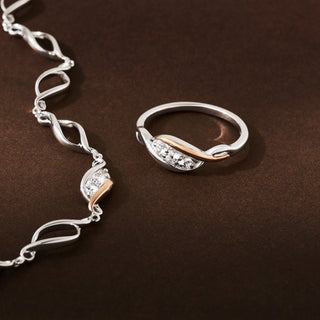 Silver bracelet and ring on a brown surface