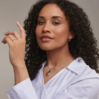 A model wearing the Clogau tree of life white topaz stacking ring