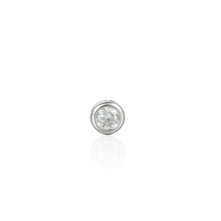 Single diamond earring on a white background