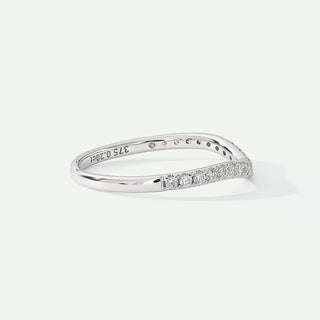 Silver ring with small diamonds on a light gray background