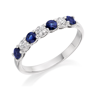 9ct white gold ring with blue sapphire and clear gemstones on a white background