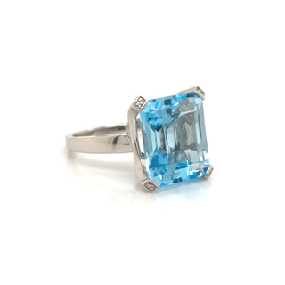 Ring with a blue gemstone on a white background
