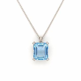 Necklace with a blue gemstone pendant on a white background
