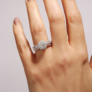 Close-up of a hand wearing a diamond ring on a light background