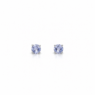 Two white gold and tanznaite earrings on a white background