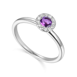 White Gold ring with a purple gemstone a white background