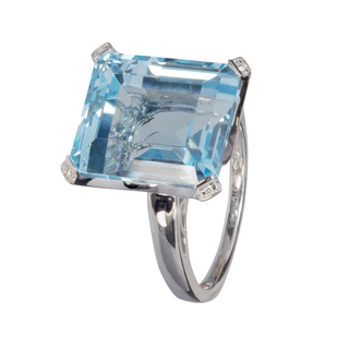 A 9ct white gold ring featuring a large, square-cut light blue gemstone with small accent diamonds on the corners, set against a plain white background.