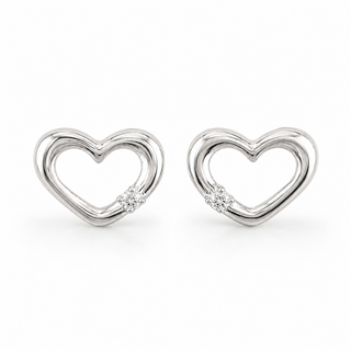 A pair of white gold heart-shaped stud earrings with a small clear gemstone at the bottom curve, set against a plain white background.