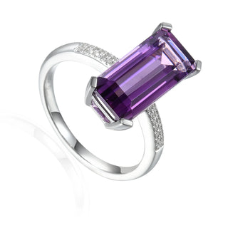 Silver ring with a purple gemstone on a white background