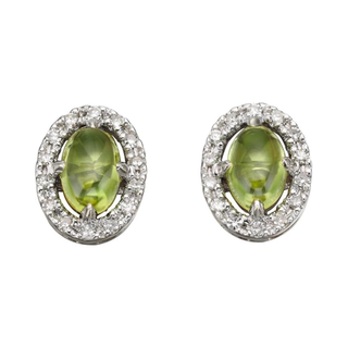 Pair of earrings with green gemstones and diamond-like stones on a white background