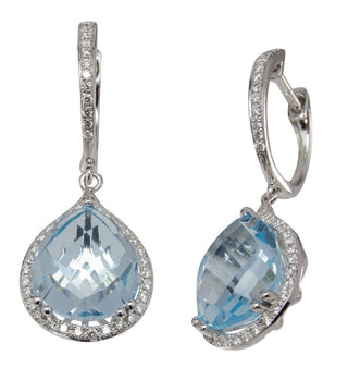 A pair of white gold drop earrings featuring large light blue teardrop-cut gemstones surrounded by small clear stones, shown on a plain white background.