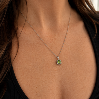 Necklace with a green pendant worn by a person