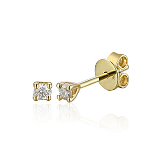 Gold earring with clear gemstones on a white background
