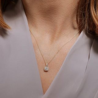 Necklace with a diamond pendant worn by a person against a neutral background