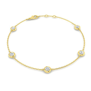 Gold bracelet with diamond accents on a white background