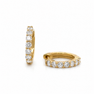 Gold hoop earrings with diamond accents on a white background