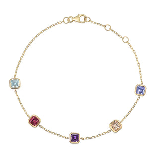 Gold bracelet with colorful gemstones on a white background