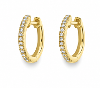 A pair of gold huggie hoop earrings adorned with a row of clear pavé-set round diamonds on the front, shown against a plain white background.